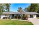 Charming single-story home featuring a white brick facade, landscaped front yard and a welcoming entrance at 4317 Ne 12Th St, Ocala, FL 34470