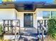 Covered front porch with black painted stairs and door, offering curb appeal at 4317 Ne 12Th St, Ocala, FL 34470