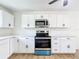 Stylish kitchen with white cabinetry, stainless microwave and oven, perfect for cooking at 4317 Ne 12Th St, Ocala, FL 34470