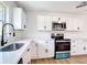 Modern kitchen featuring white cabinets, stainless steel appliances, and quartz countertops at 4317 Ne 12Th St, Ocala, FL 34470