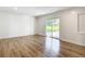 Bright living room with new floors and sliding glass doors overlooking a landscaped yard at 4317 Ne 12Th St, Ocala, FL 34470