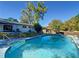 Backyard pool features pool-side patio, with mature trees and lush landscaping at 4317 Ne 12Th St, Ocala, FL 34470