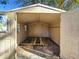 Empty shed with paneled interior, open doors, and some wood remnants on the floor at 4317 Ne 12Th St, Ocala, FL 34470