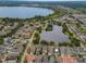 Aerial view of a neighborhood featuring lush landscaping, multiple ponds and a community pool at 5342 Horton Ln, Orlando, FL 32814