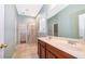 Bathroom with double sink vanity, tile flooring, and a walk-in shower with a glass door at 5342 Horton Ln, Orlando, FL 32814