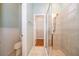 Bathroom featuring tile flooring, a walk-in shower, and view of the walk-in closet at 5342 Horton Ln, Orlando, FL 32814