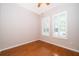 A bright bedroom has a ceiling fan, hardwood floors, and windows with shutters at 5342 Horton Ln, Orlando, FL 32814