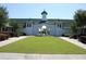 Exterior of the clubhouse showcasing its architectural design, manicured lawn, and inviting entrance at 5342 Horton Ln, Orlando, FL 32814