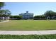 Expansive community green space, well-maintained lawn, mature trees, and an attractive building in the background at 5342 Horton Ln, Orlando, FL 32814