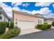 Exterior view of a pink house with a two-car garage and landscaping around the driveway at 5342 Horton Ln, Orlando, FL 32814