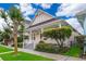 Charming pink house with a porch, stairs, white railings and landscaping on the front lawn at 5342 Horton Ln, Orlando, FL 32814