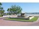 Elegant fountain feature at the entrance with a view of the water and surrounding landscape at 5342 Horton Ln, Orlando, FL 32814