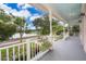 Inviting front porch with picturesque lake view, offering a perfect space for relaxation and enjoying the scenery at 5342 Horton Ln, Orlando, FL 32814