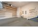 A spacious garage with multiple rows of shelving and a white staircase at 5342 Horton Ln, Orlando, FL 32814