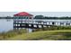 Picturesque gazebo on a dock extending into the lake, surrounded by lush green lawns and serene water views at 5342 Horton Ln, Orlando, FL 32814