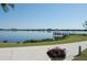 Scenic view of a gazebo on a pier extending into a tranquil lake, complemented by a flower pot at 5342 Horton Ln, Orlando, FL 32814