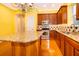 Bright eat-in kitchen with wood cabinets, granite countertops, stainless appliances and a kitchen island at 5342 Horton Ln, Orlando, FL 32814