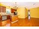 Bright kitchen features wood cabinets, an island, stainless appliances and a view of the living area at 5342 Horton Ln, Orlando, FL 32814