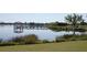 Scenic lake view featuring a pier, gazebo, and lush surroundings, offering a peaceful retreat at 5342 Horton Ln, Orlando, FL 32814