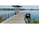 Picturesque view of a wooden pier extending into a serene lake with clear blue water at 5342 Horton Ln, Orlando, FL 32814