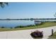 Beautiful lake view with a gazebo on a dock and colorful flowers in the foreground at 5342 Horton Ln, Orlando, FL 32814