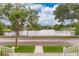 Scenic view of a serene lake, trees, and blue skies from the front porch of this charming home at 5342 Horton Ln, Orlando, FL 32814