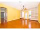 Open-concept living room with built-in bookshelves and French doors leading to the backyard at 5342 Horton Ln, Orlando, FL 32814