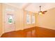 Bright living room with hardwood floors, ceiling fan, plantation shutters, and ample natural light at 5342 Horton Ln, Orlando, FL 32814