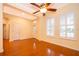Bright living room featuring gleaming hardwood floors, plantation shutters, and ceiling fan at 5342 Horton Ln, Orlando, FL 32814
