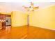 Open-concept living room features hardwood floors, ceiling fan, and an open view of the kitchen at 5342 Horton Ln, Orlando, FL 32814
