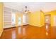 Spacious living room with hardwood floors, built-in shelves, and French doors leading to the backyard at 5342 Horton Ln, Orlando, FL 32814
