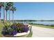 A scenic waterfront view of a dock extending into a serene lake with a flower pot in the foreground at 5342 Horton Ln, Orlando, FL 32814