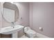 Powder room features a modern pedestal sink, toilet, and neutral wall color at 571 Masalo Pl, Lake Mary, FL 32746