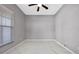 Neutral bedroom features tile floors, a window with blinds, and ample space at 571 Masalo Pl, Lake Mary, FL 32746