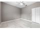 Neutral bedroom with light gray walls, ceiling fan and tile floors at 571 Masalo Pl, Lake Mary, FL 32746