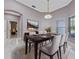 Formal dining area with stylish chandelier, wainscoting and views of a bedroom at 571 Masalo Pl, Lake Mary, FL 32746