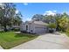 Charming home with a two-car garage, mature landscaping, and long driveway at 571 Masalo Pl, Lake Mary, FL 32746