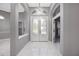 Bright foyer with marble floors, decorative glass double doors and elegant chandelier at 571 Masalo Pl, Lake Mary, FL 32746
