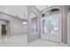 Foyer with marble flooring, elegant light fixture, and decorative front doors at 571 Masalo Pl, Lake Mary, FL 32746