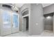 Elegant foyer featuring double doors with decorative glass and a modern chandelier at 571 Masalo Pl, Lake Mary, FL 32746