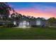 Charming single-story home featuring a lush lawn, brick pathway, and mature landscaping at 571 Masalo Pl, Lake Mary, FL 32746