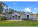 Charming single-story home featuring a brick driveway, well-manicured lawn, and lush landscaping at 571 Masalo Pl, Lake Mary, FL 32746