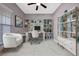 A home office with built-in bookshelves, desk, and white marble tile floor at 571 Masalo Pl, Lake Mary, FL 32746