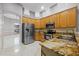 Spacious kitchen with stainless steel appliances and granite countertops at 571 Masalo Pl, Lake Mary, FL 32746