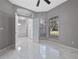 Bright living room with marble floors, windows, ceiling fan and open doorway at 571 Masalo Pl, Lake Mary, FL 32746
