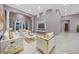 A spacious living room featuring stylish white furniture and an entertainment center at 571 Masalo Pl, Lake Mary, FL 32746