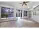 Bright sunroom featuring tile floors, large windows, and access to the outdoors at 571 Masalo Pl, Lake Mary, FL 32746
