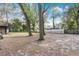 Spacious backyard with mature trees and partial fence line, offering privacy and space for outdoor activities at 1660 Killean Ct, Apopka, FL 32712