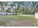Large, grassy backyard enclosed by a white fence and bordered by mature trees at 1660 Killean Ct, Apopka, FL 32712