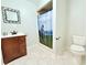 Bathroom with a wood vanity, large mirror, and golf-themed shower curtain at 1660 Killean Ct, Apopka, FL 32712